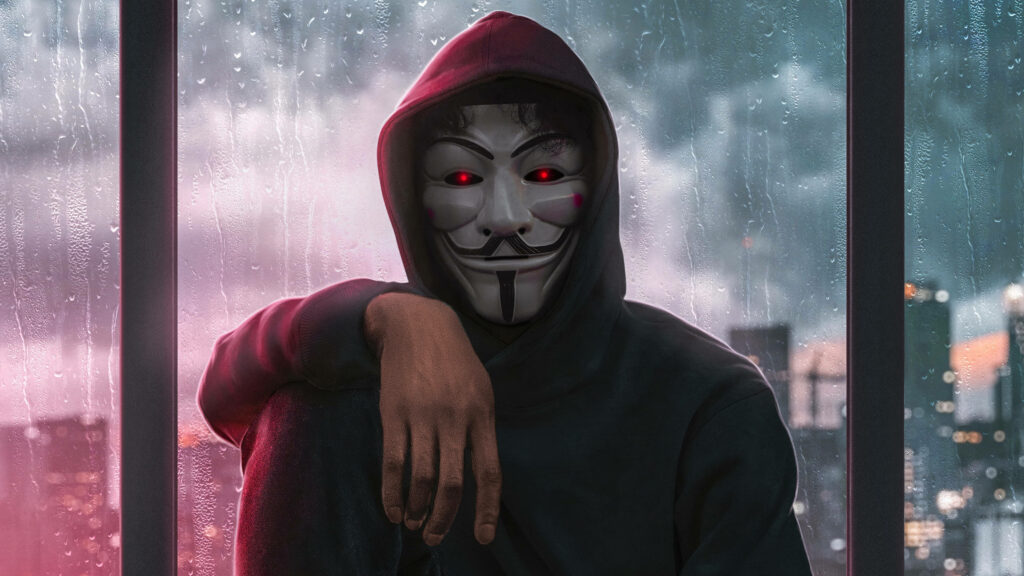 The Mysterious Observer: Unveiling The Illusion Behind the Hacker's Mask Against a Rainy Window Background Wallpaper