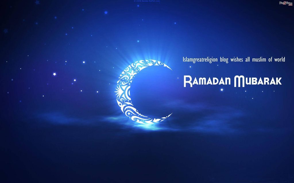 Serene Ramadan Mubarak wallpaper with glowing crescent moon and Islamic patterns on blue night sky