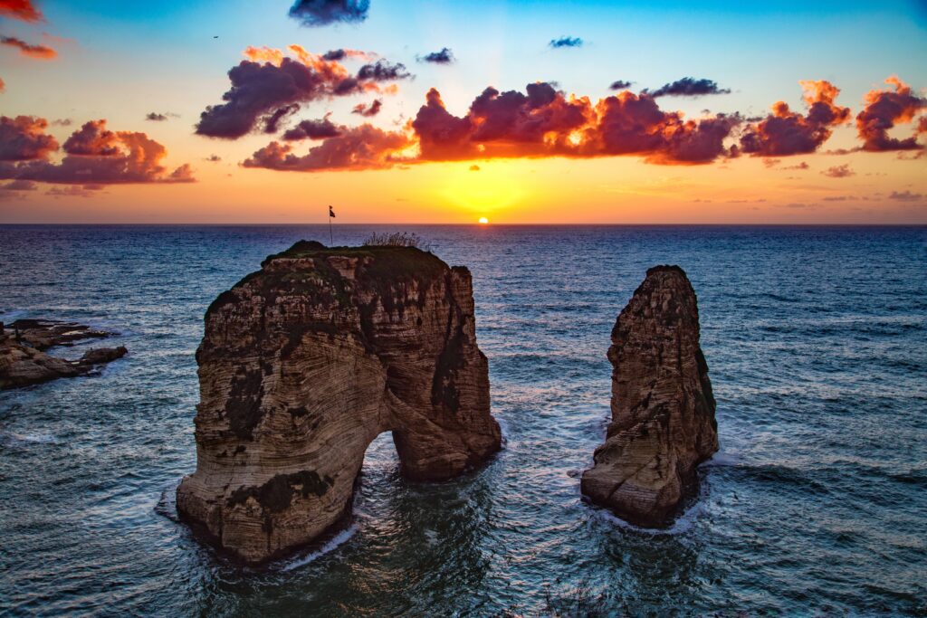 Raouche Rocks Beirut sunset orange red blue sky coastal landmark scenic wallpaper background