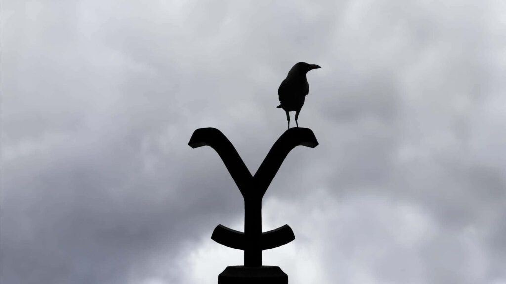 Moody Raven Silhouette Wallpaper: Yellowstone Sign & Cloudy Sky
