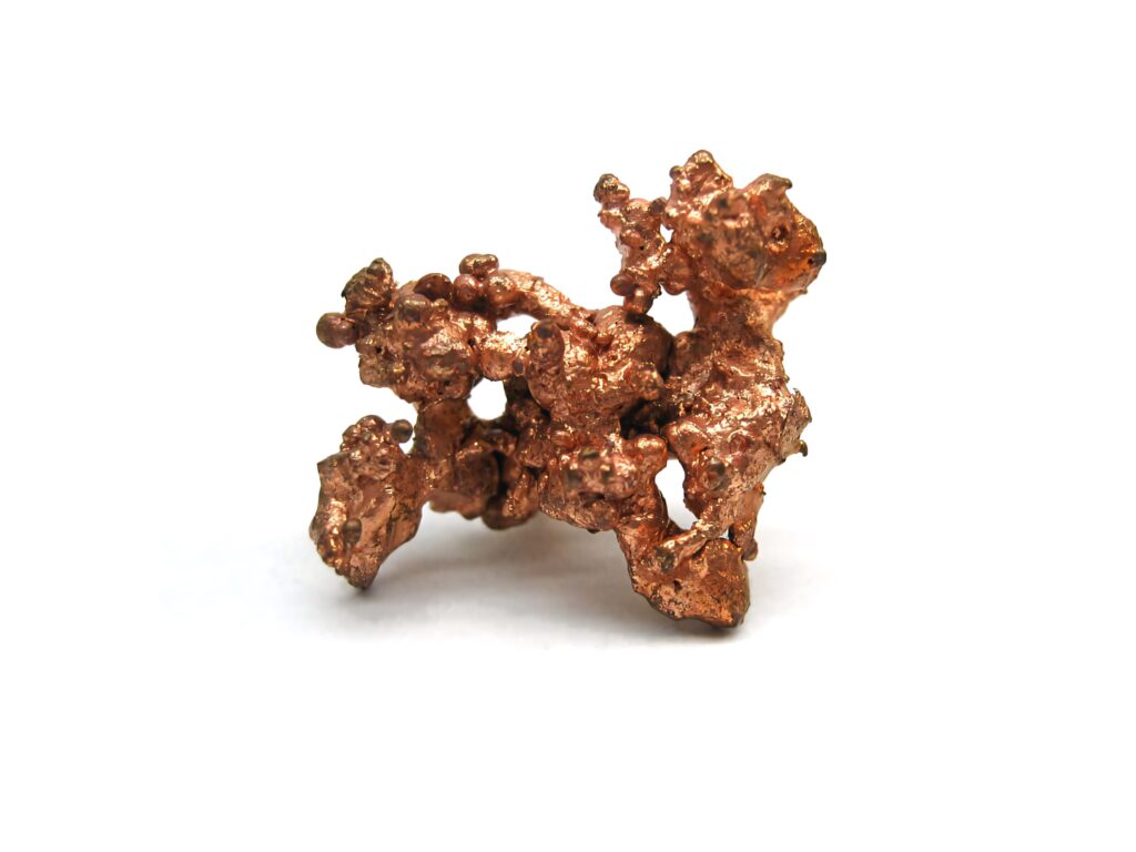 Close-up of natural copper nugget with rough texture and rich metallic reddish brown tones on white background Wallpaper