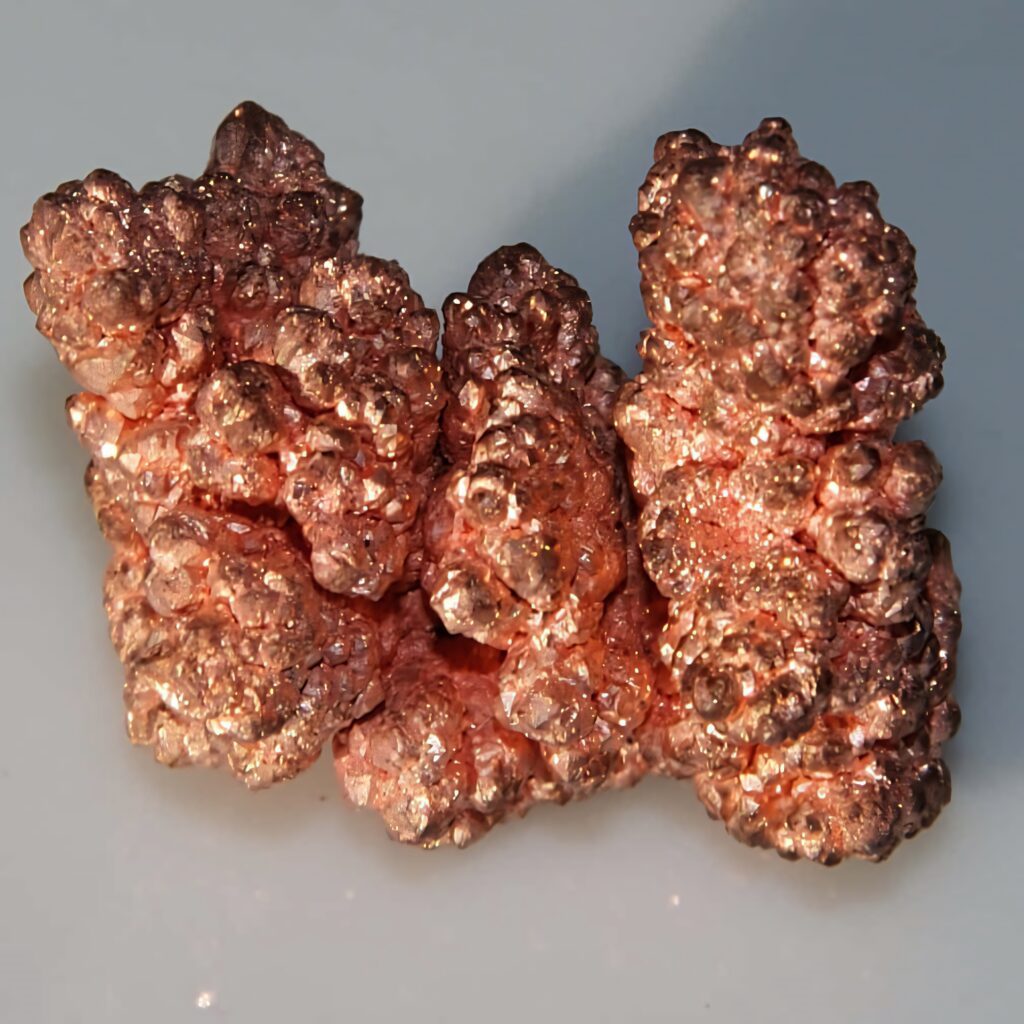 Close-up of natural copper metal with vivid reddish-orange hues and rugged metallic texture wallpaper