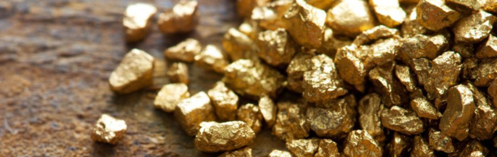 Close-up of shiny raw gold nuggets on rustic wood with warm lighting natural wealth texture Wallpaper