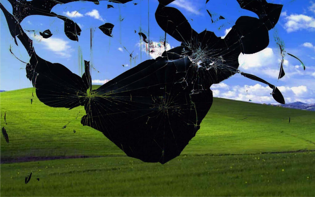 Realistic broken screen effect over Windows Bliss background desktop wallpaper dramatic illusion
