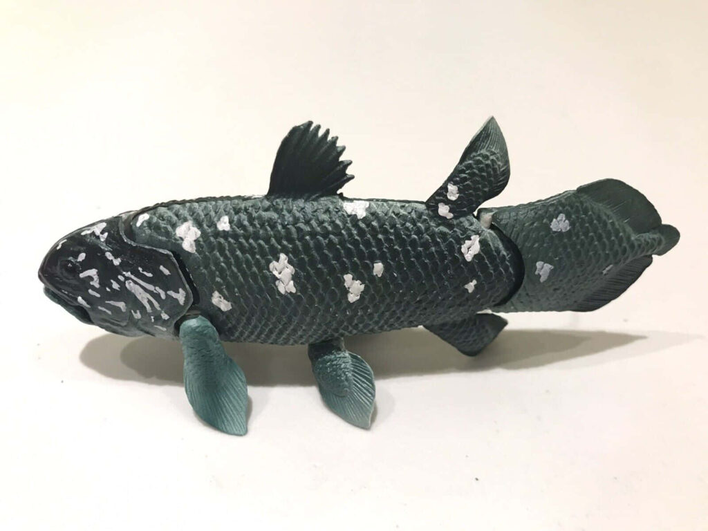 Detailed coelacanth model wallpaper with realistic texture dark green hues and white spots