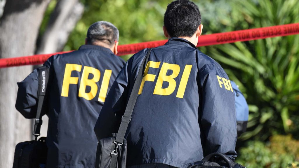 Two FBI agents in navy jackets by red crime scene tape intense investigation wallpaper background