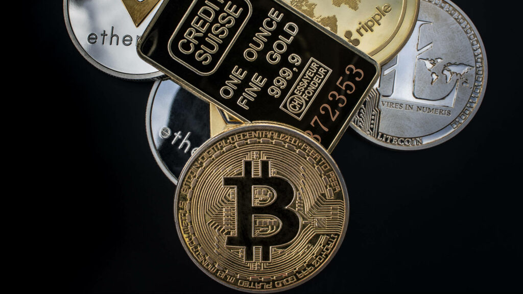 Realistic gold Ethereum coin with Bitcoin Ripple and other crypto tokens on dark background wallpaper
