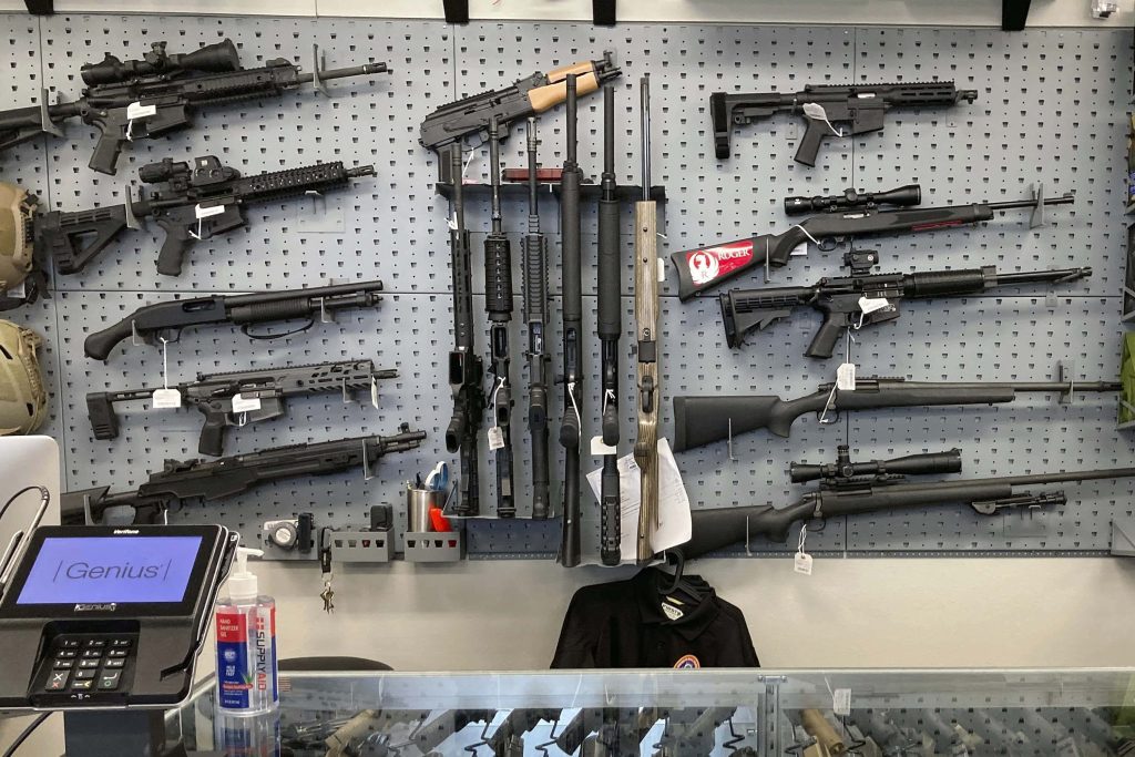 Realistic gun shop interior with various rifles shotguns Ruger on grey pegboard wall wallpaper