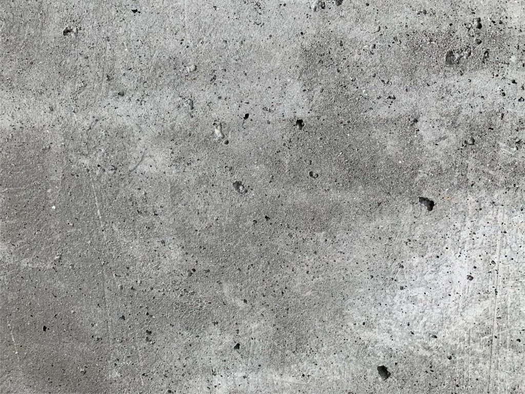 Close-up high-resolution concrete texture wallpaper in raw industrial gray for minimalist backgrounds