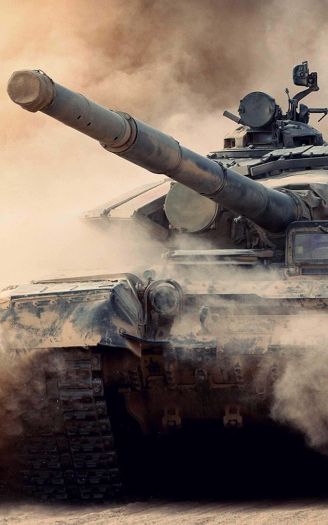 Main battle tank charging through dusty desert high detail rugged armor massive cannon wallpaper