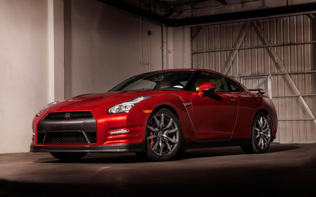 Red 2015 Nissan R35 GTR sports car in sleek indoor setting luxury design wallpaper background