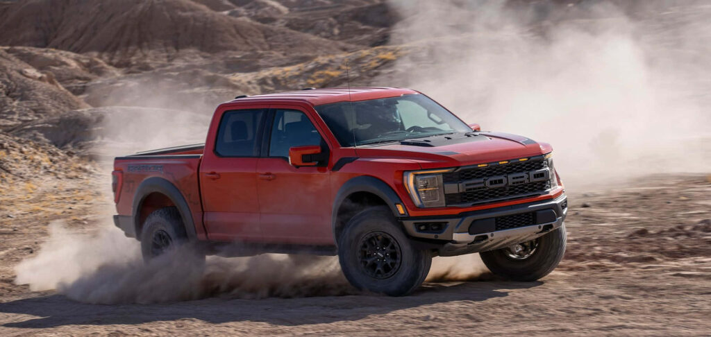 Red 2019 Ford F-150 speeding through dusty desert showcasing rugged powerful truck adventure Wallpaper