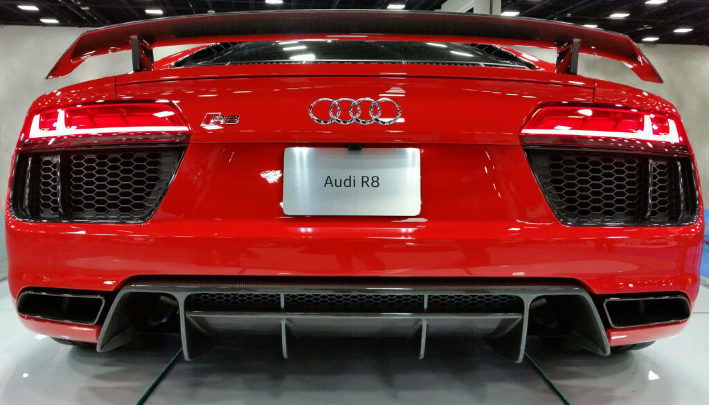 Rear view of red Audi R8 with aggressive bumper and distinctive taillights wallpaper background