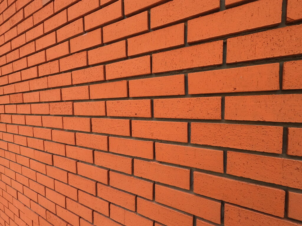 Vibrant Red Brick Wall: Captivating 4K Wallpaper Background with Textured Detail