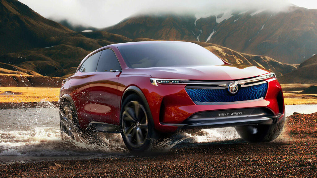 Red Buick Enclave driving through shallow water with dramatic mountain background wallpaper
