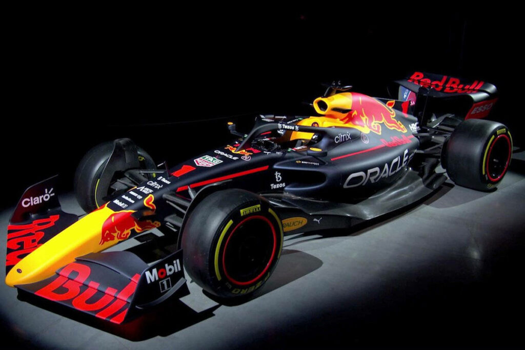 Red Bull Racing car illuminated in dark room showcasing sleek design vibrant colors wallpaper