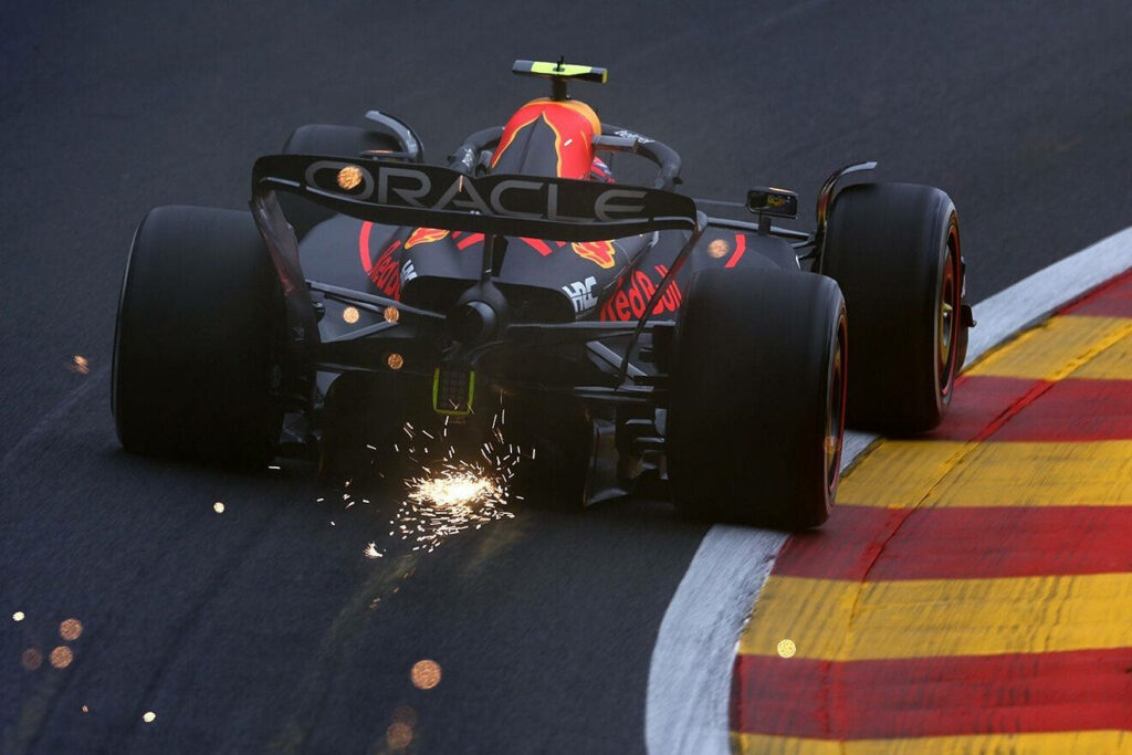 Red Bull Racing Formula 1 car sparking at high speed cornering on racetrack dynamic wallpaper