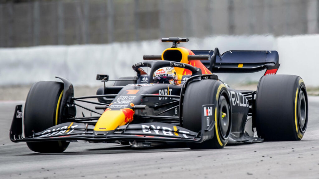 Red Bull Racing Formula 1 car speeding on track with sleek front wing and vibrant colors wallpaper