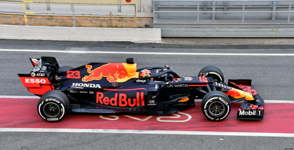 Red Bull Racing Formula 1 car in bold red and blue on Catalunya circuit pit lane wallpaper