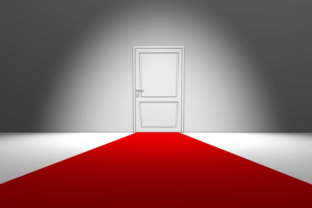 3D red carpet leading to white door with minimalist gray wall studio lighting wallpaper background