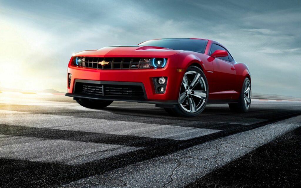 Red Chevrolet Camaro Wallpaper - Bold Design Against Dramatic Sky