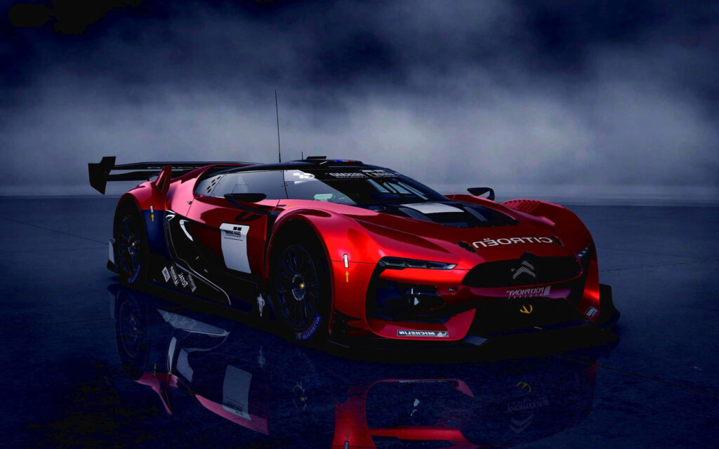 Red Citroen race car on reflective surface with misty background showcasing aerodynamic design Wallpaper