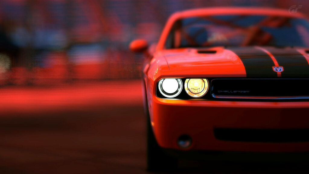 Red Dodge Challenger front close-up with bold black stripes and glowing headlights wallpaper