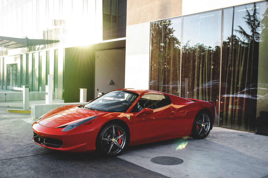 Sleek Red Ferrari 458 Spyder in Urban Setting - Stunning Wallpaper