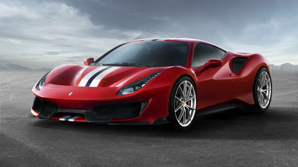 Roaring Beast in a Desert Oasis: The Furious Red Ferrari 488 Pista Surrounded by Majestic Mountains Wallpaper