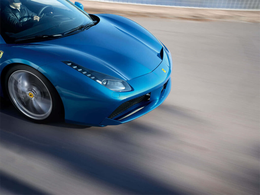 Blue Ferrari 488 Spider on a Road Background Wallpaper