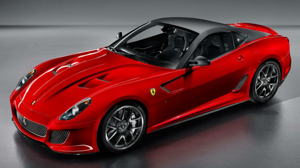 Captivating Speed: Red Ferrari 599 GTB Fiorano Roars against a Sleek Gray Canvas Wallpaper