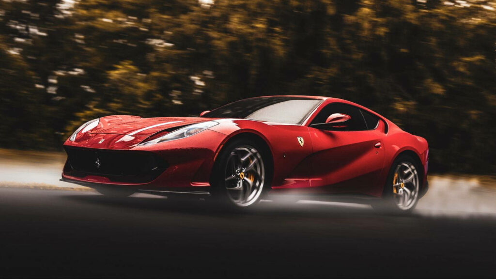 Blazing Through the Enchanted Forest: The Sleek Red Ferrari 812 Superfast Wallpaper