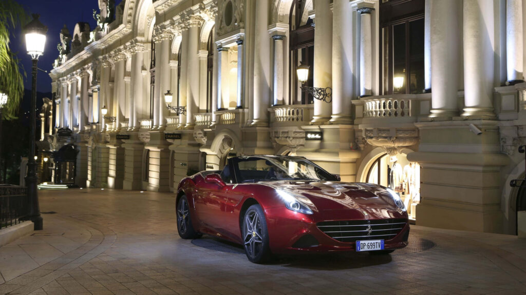Cruising in Style: Captivating High-Resolution Shot of a Red Ferrari California T Showcasing its Striking Design and Raw Power on a Scenic Road Wallpaper