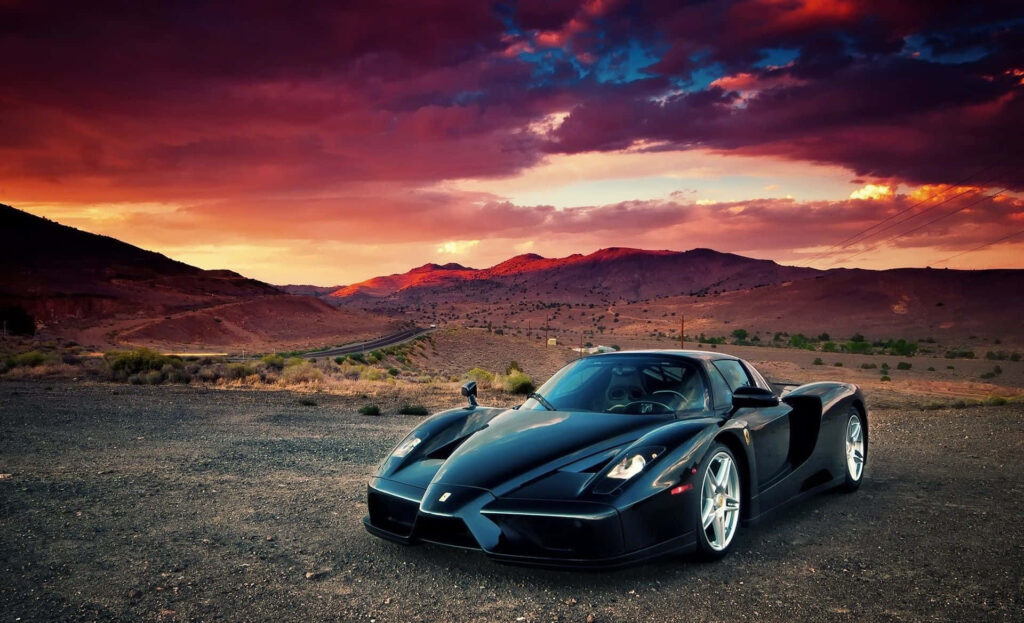 Black Ferrari Enzo on a Road - Mountains Background Wallpaper