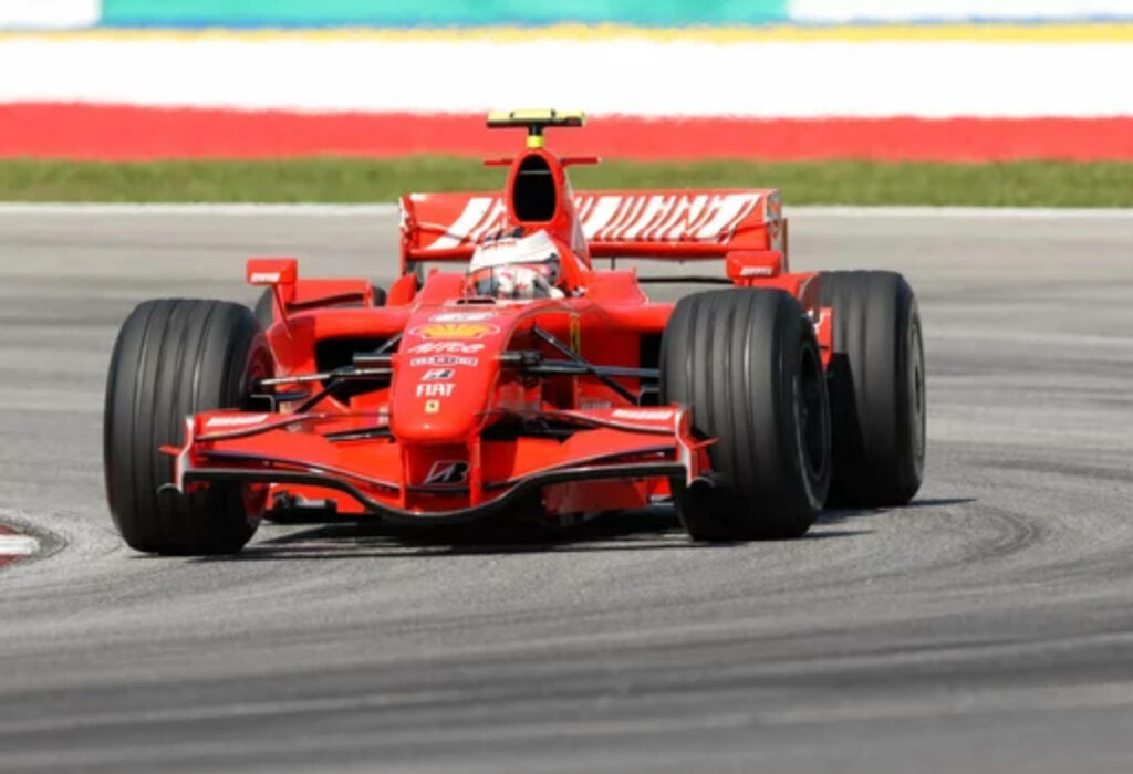 Red Ferrari F1 car racing on track 4K wallpaper showcasing sleek design and speed performance