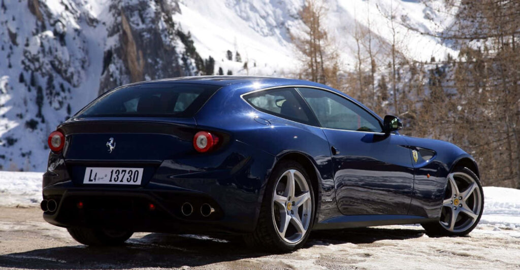 Captivatingly Sleek: Embracing the Majestic Journey of a Red Ferrari FF amidst Enchanting Scenery Wallpaper