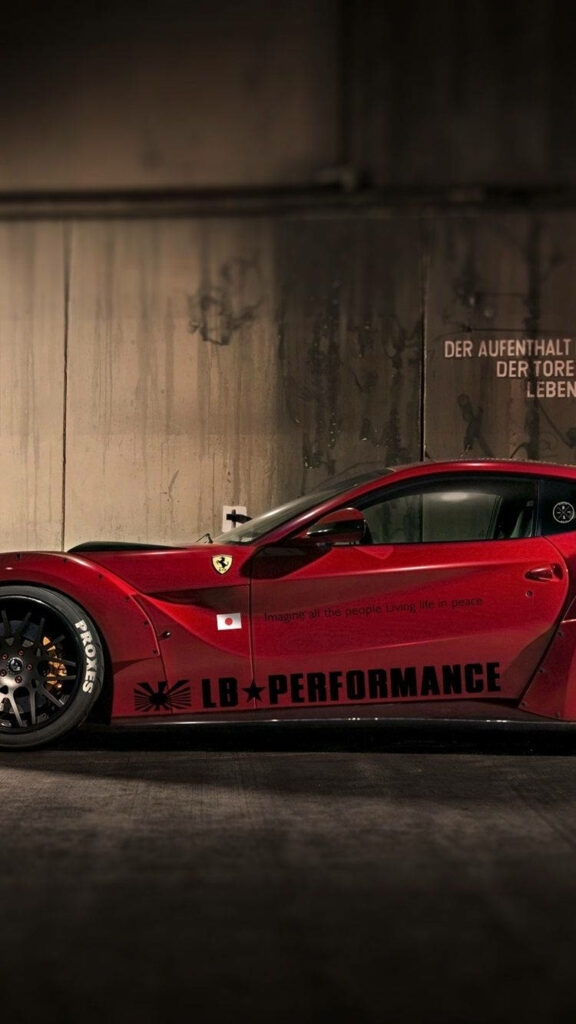 Red Ferrari LB Performance with sleek custom bodywork and bold decals on urban concrete background Wallpaper