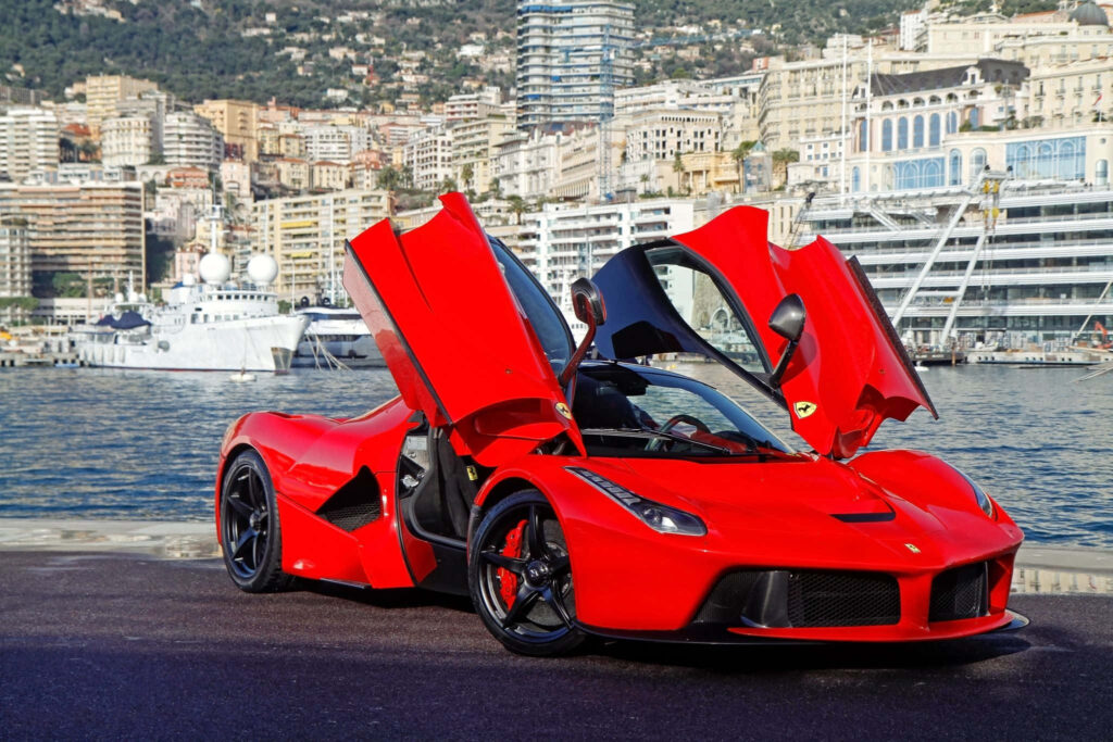 Speed, Luxury, and Elegance Unleashed: The Iconic Red Ferrari LaFerrari Shines Amidst Breathtaking Scenery Wallpaper