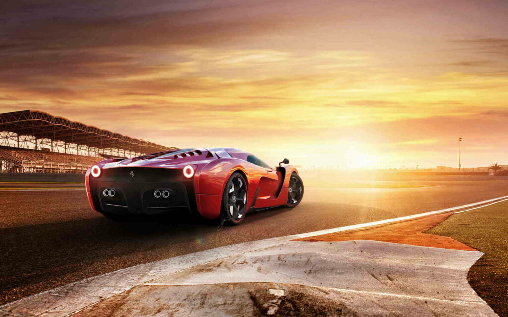 Red Ferrari racing on track at sunset with vivid orange sky in Project Cars 2 wallpaper