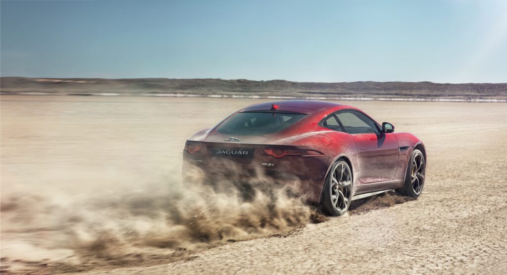 Red Jaguar F-Type R Racing Through Desert | High-Speed Wallpaper