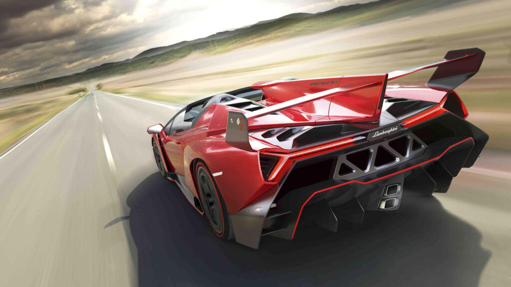 Red Lamborghini sports car speeding on open road showcasing sleek design and powerful performance Wallpaper