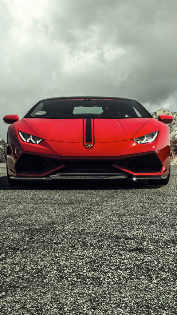 Red Lamborghini sports car on asphalt under dramatic cloudy sky modern iPhone wallpaper background