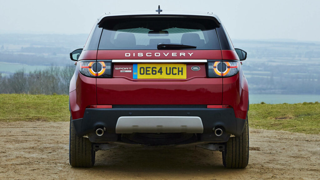 Red Land Rover Discovery Sport in Countryside - iPhone Wallpaper