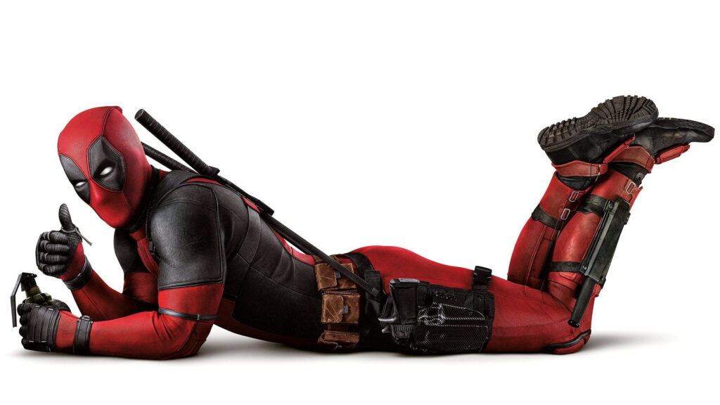 Deadpool in red black suit lounging with live grenade and thumbs up on white background wallpaper
