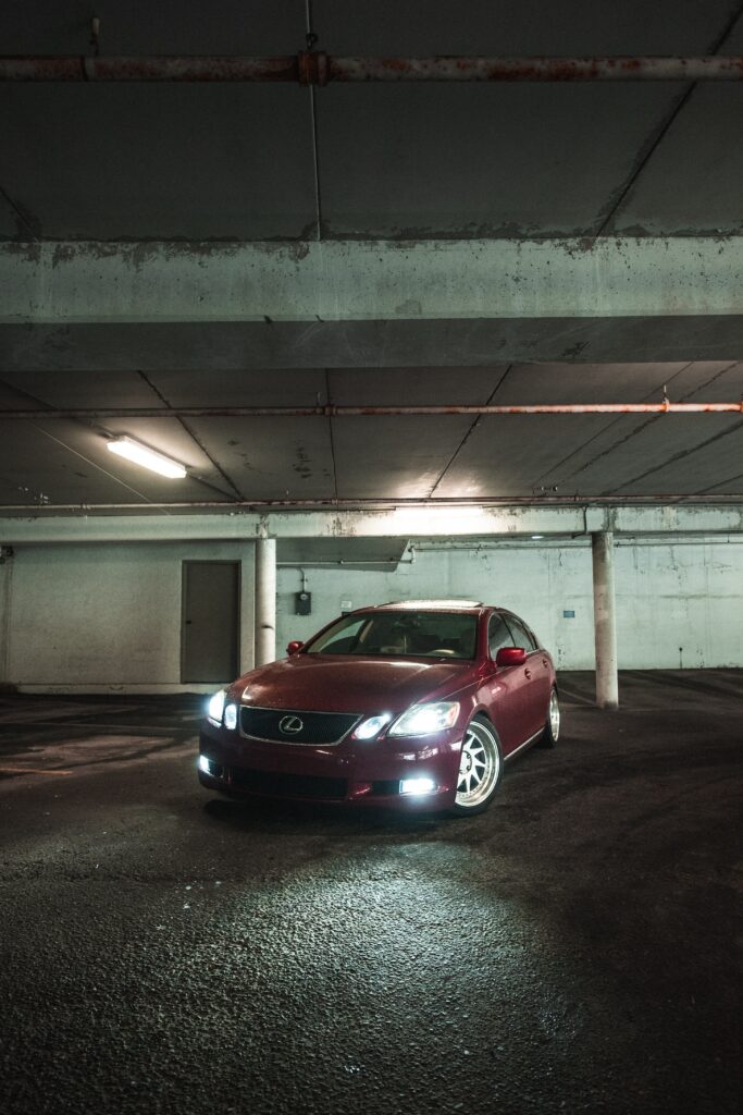 Sleek Red Lexus in Dimly Lit Garage: Stylish Wallpaper Design