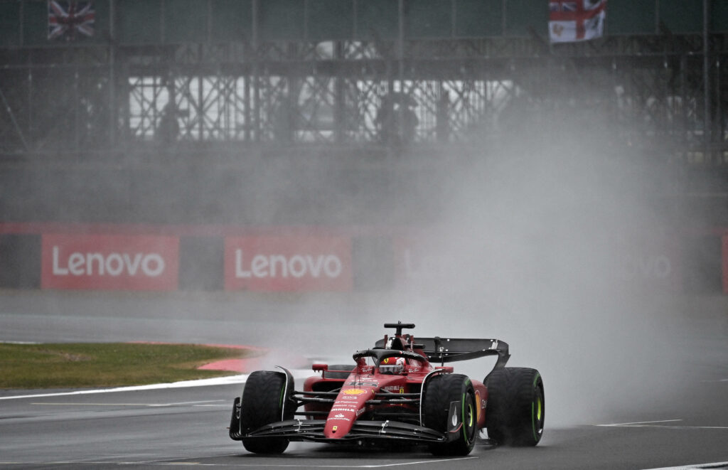 The Thrilling Wet Silverstone Race: Carlos Sainz Jr Dazzles Behind the Wheel of a Bold Red F1 Car Wallpaper