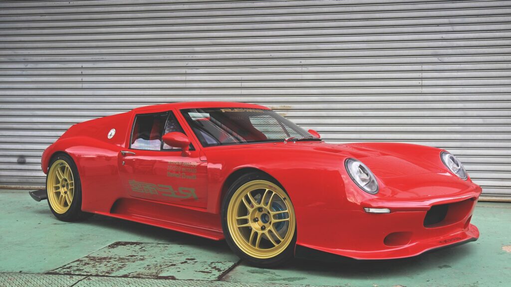 Red Lotus Europa: Sleek Side View Wallpaper with Industrial Background