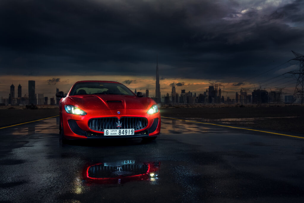 Red Maserati GranTurismo MC Stradale in Dramatic Cityscape Wallpaper