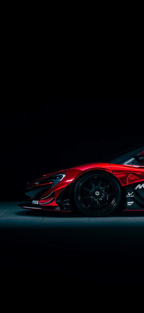 Red McLaren P1 GTR on racetrack in dramatic lighting ideal iPhone wallpaper for car enthusiasts