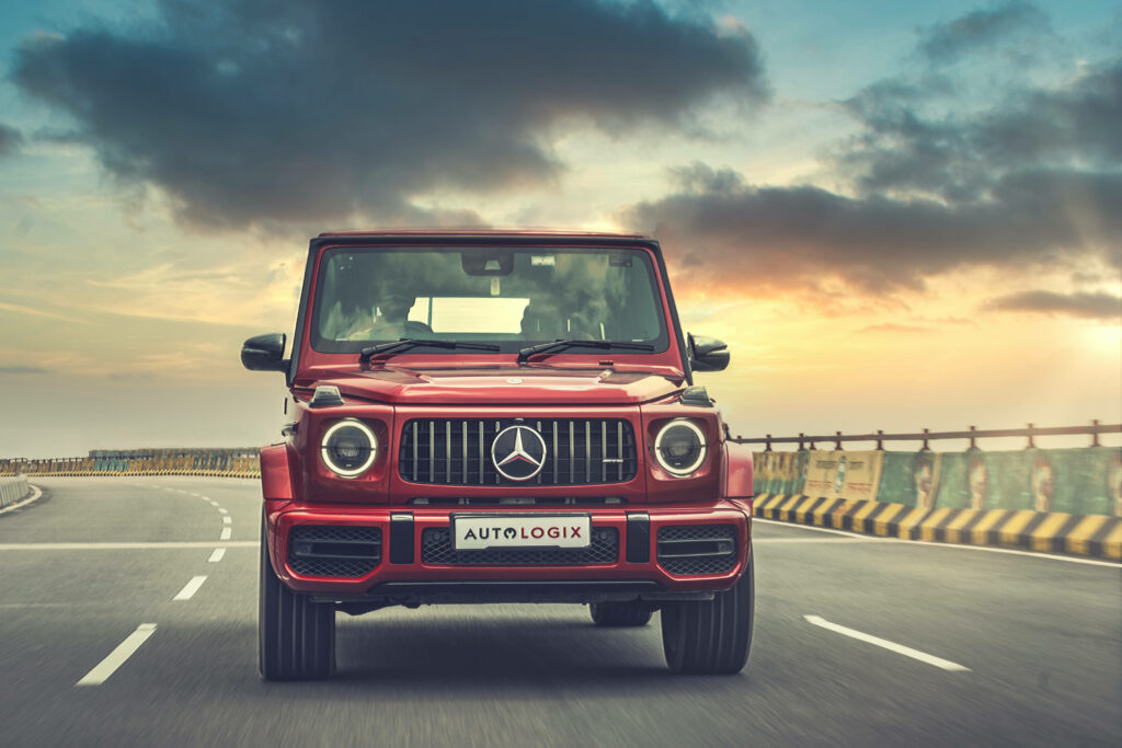 Red Mercedes-Benz G-Class on open road sunset luxury SUV 4K wallpaper background image